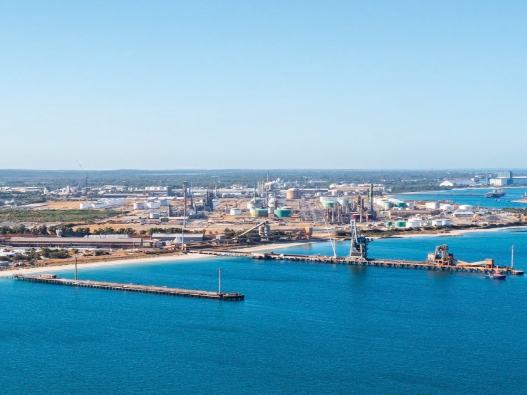 Aerial photo of the Kwinana Industrial Area from the see, two jetties are in the foreground.