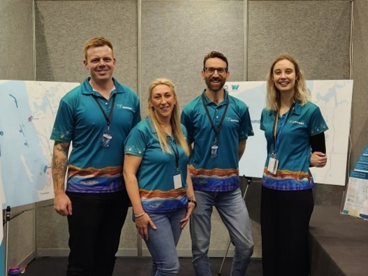 Westport team members standing in front of maps of the project area at the Club Marine Perth Boat Show. 