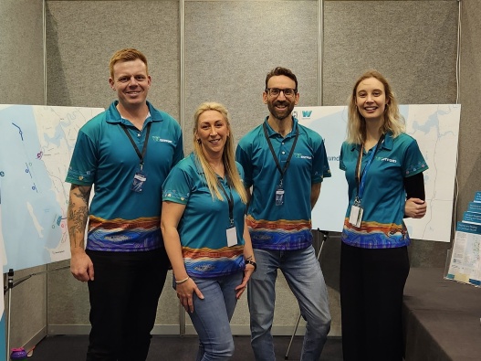 Westport team members standing in front of maps of the project area at the Club Marine Perth Boat Show.