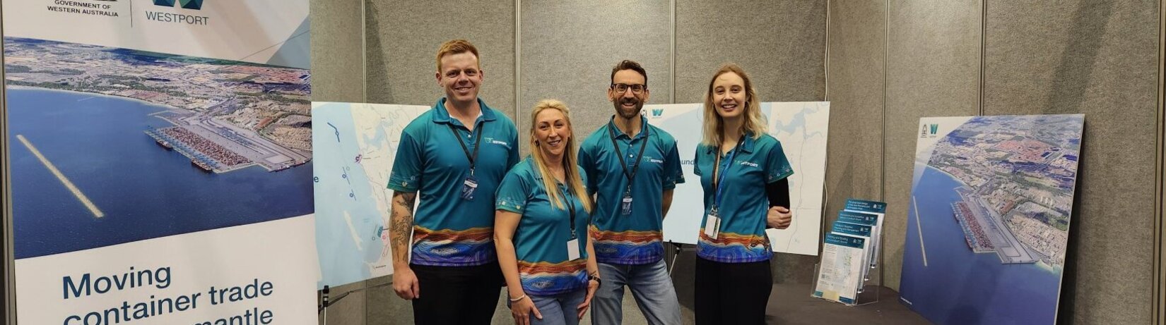 Westport team members, smiling in a Westport-branded booth at the Perth Boat Show.
