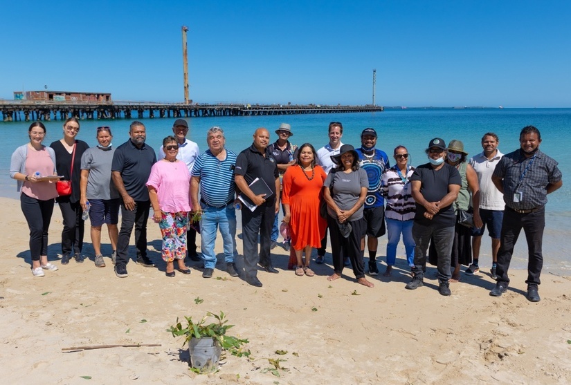 a group of people standing on a beach