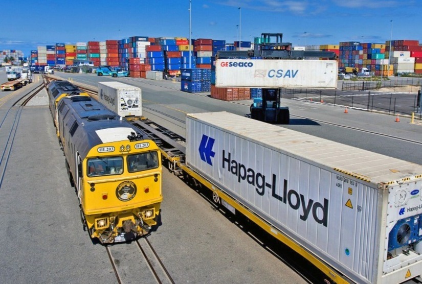 Photo of intermodal container terminal with rail and trucks in view.