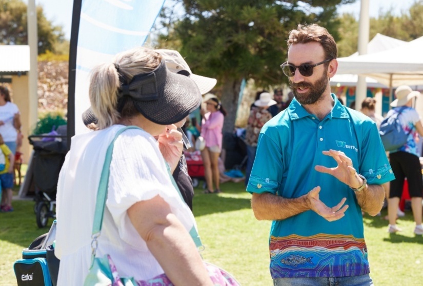 Westport team member chatting with two community members