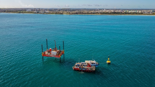 Jack up barge and work boats on Cockburn Sound conducting geotechnical investigations