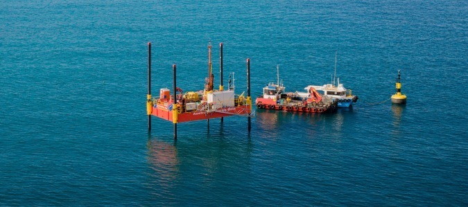 Photo of a barge and small vessel in the Cockburn Sound.